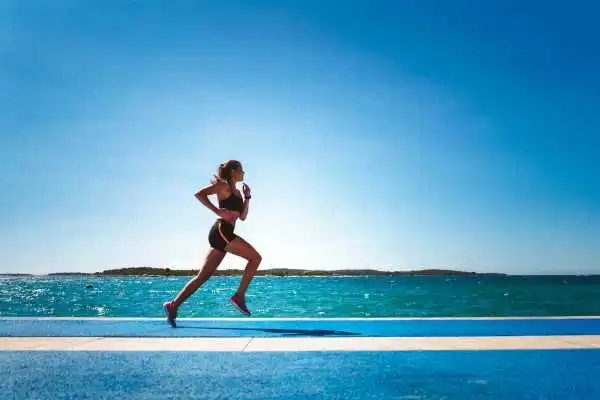 Woman running showing strong leg muscle Tonbridge